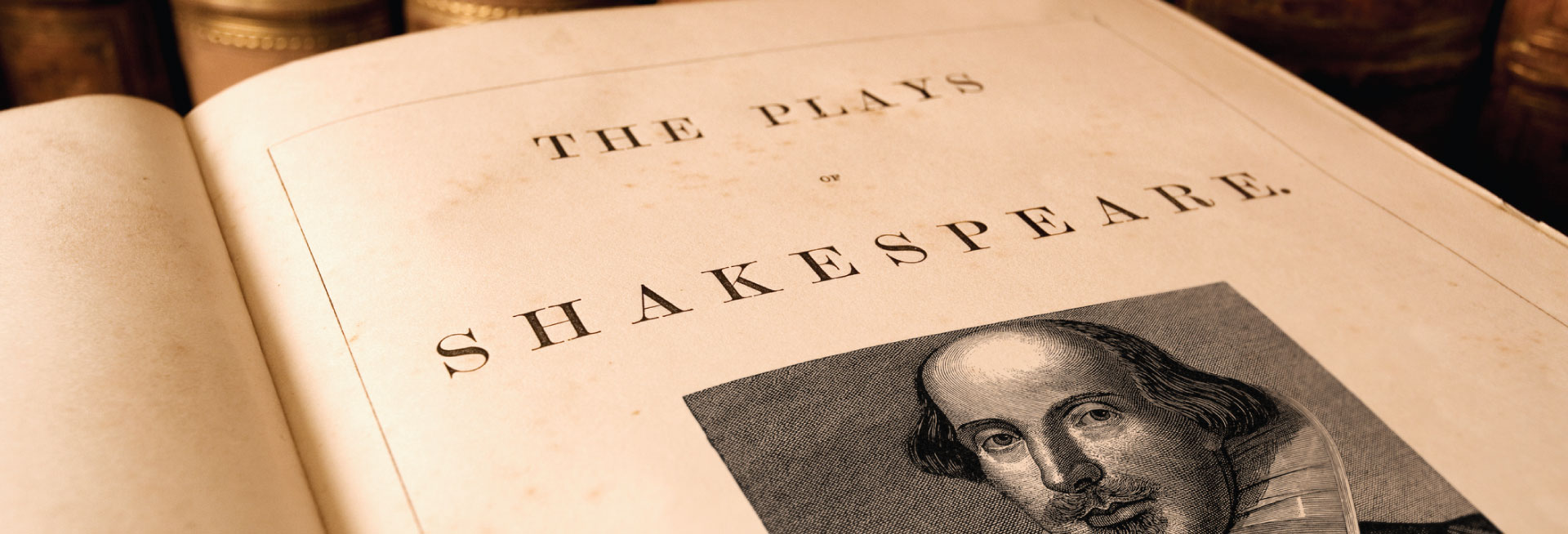 A page of a book featuring a drawing of William Shakespeare and the words "The Plays of Shakespeare".