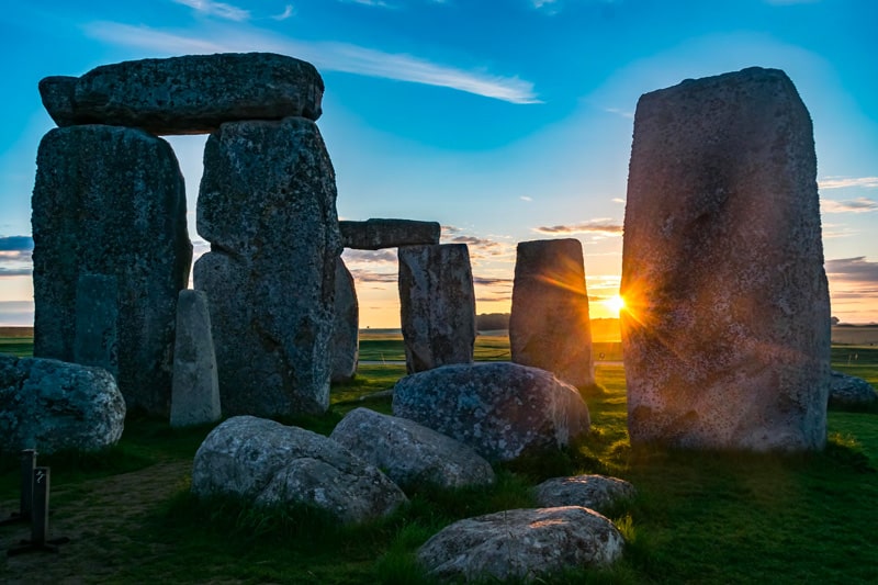 Sun flaring from behind one of the sarsen stones at Stonehenge