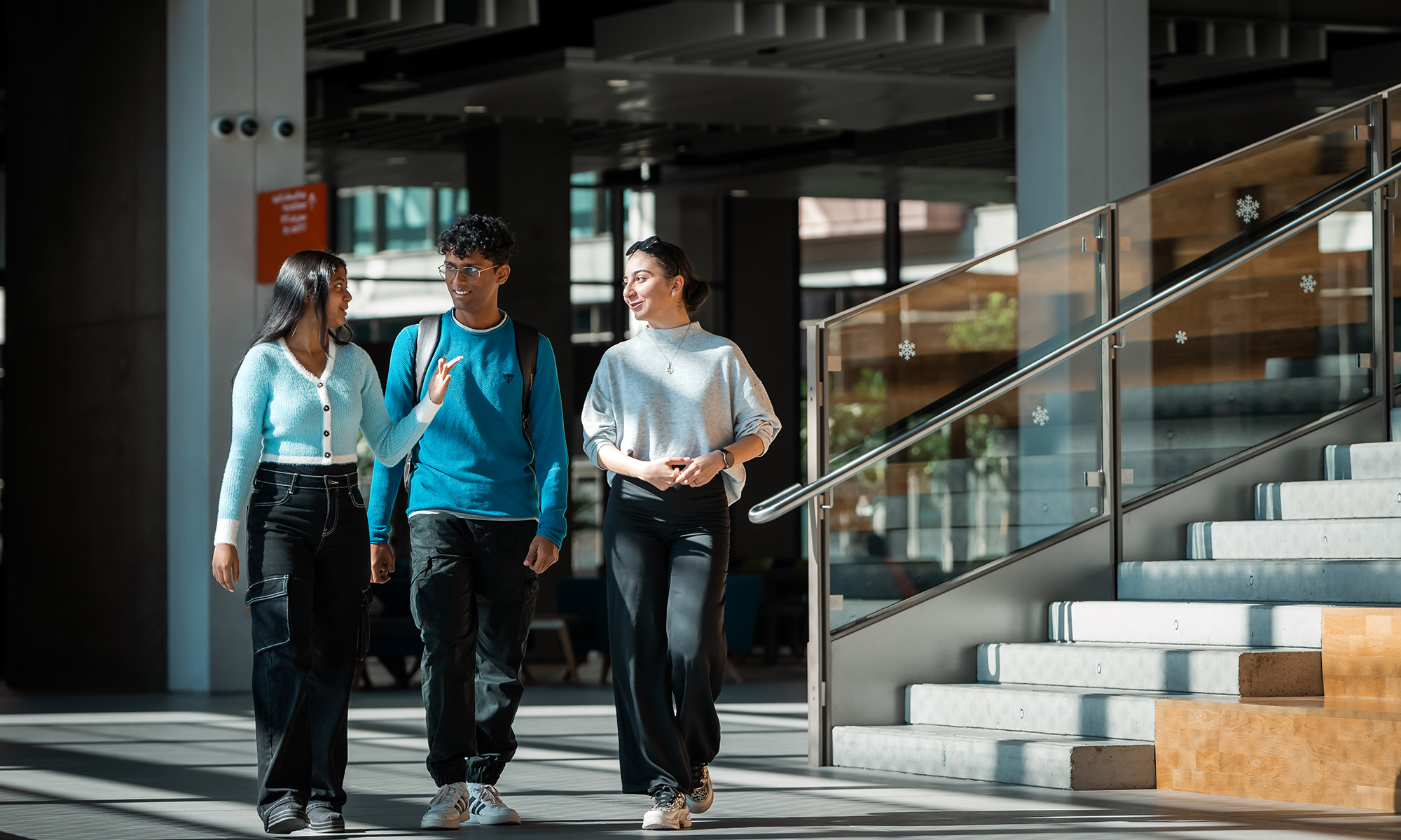 Students walking across the University of Birmingham Dubai campus