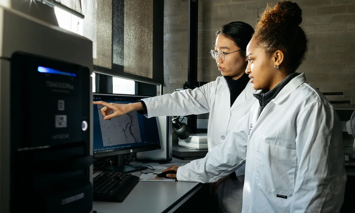 Two students working on an experiment in a lab