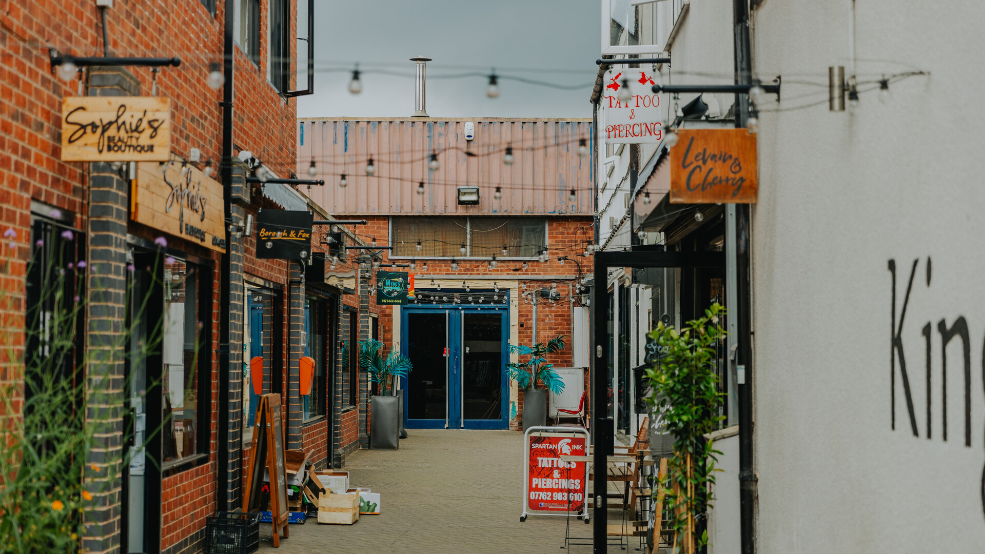 Trendy shops and stores in an alley of moseley birmingham. Food, drinks and clothing stores.