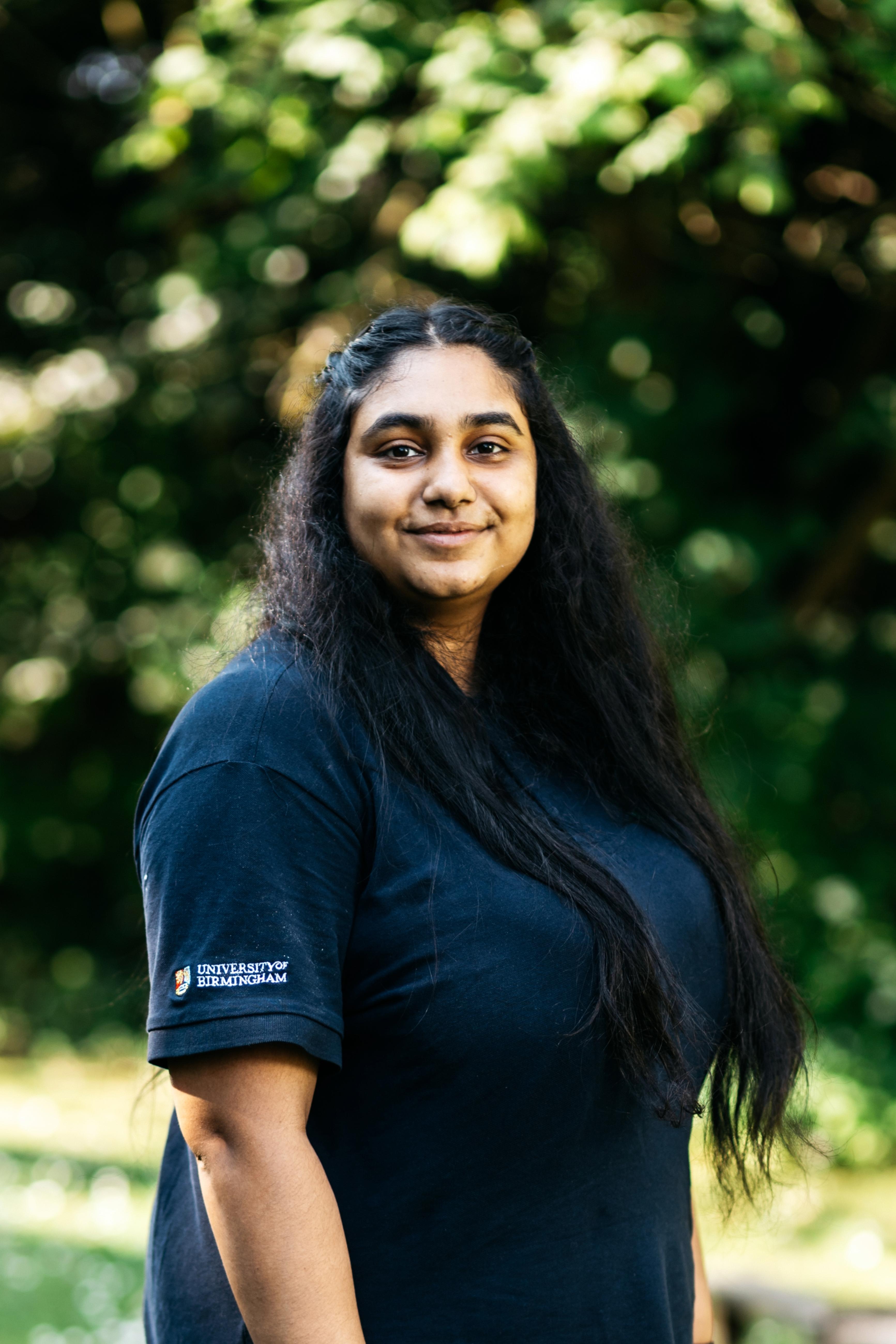 A portrait photo of Priya in her staff uniform