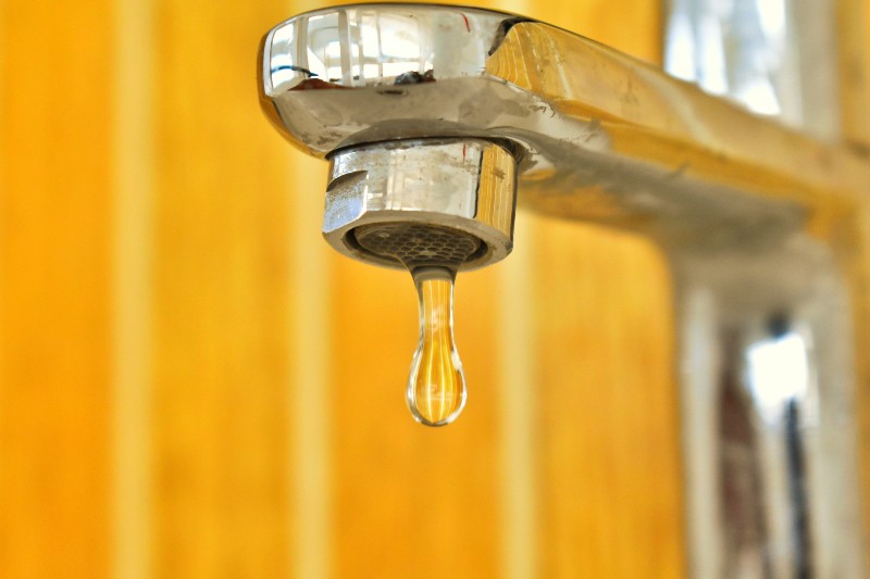 A dripping tap with orange background
