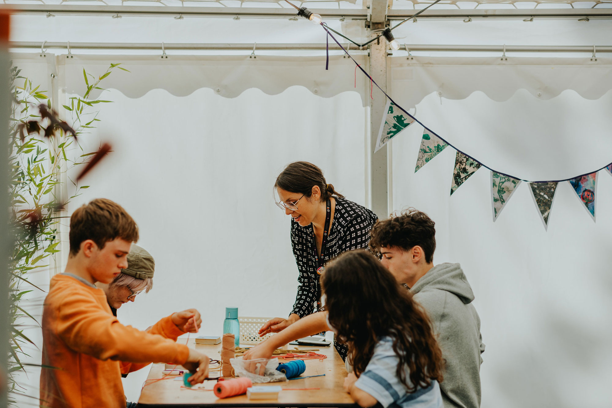 A teacher doing arts and crafts with some students