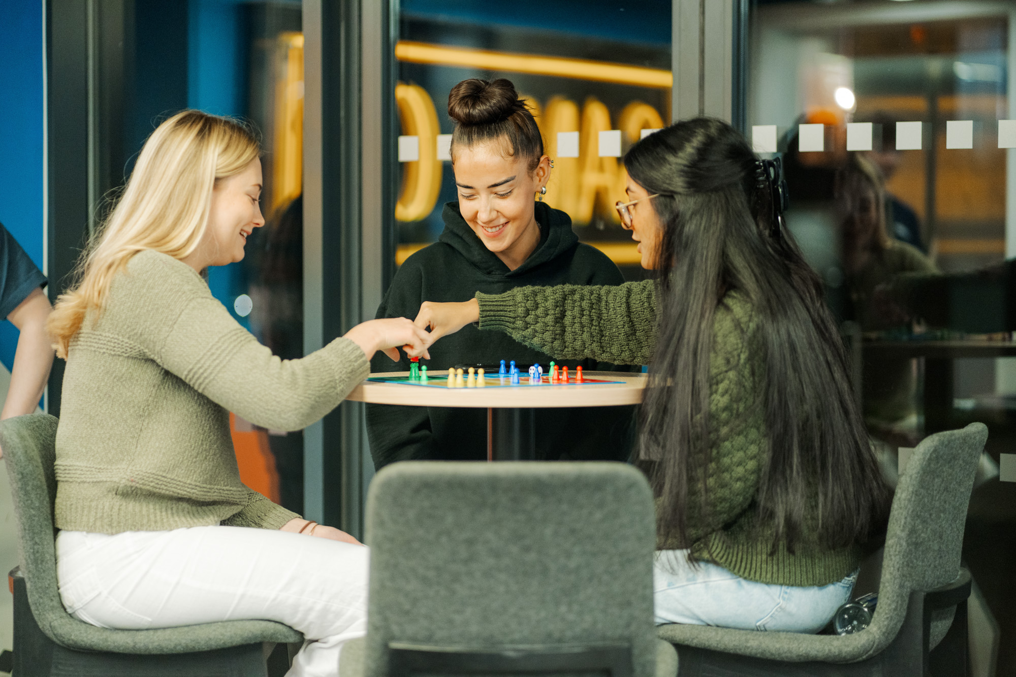 Three students playing a game together