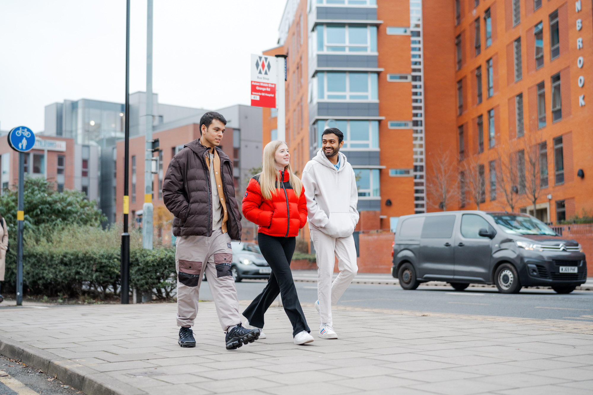 Three students walking around Selly Oak