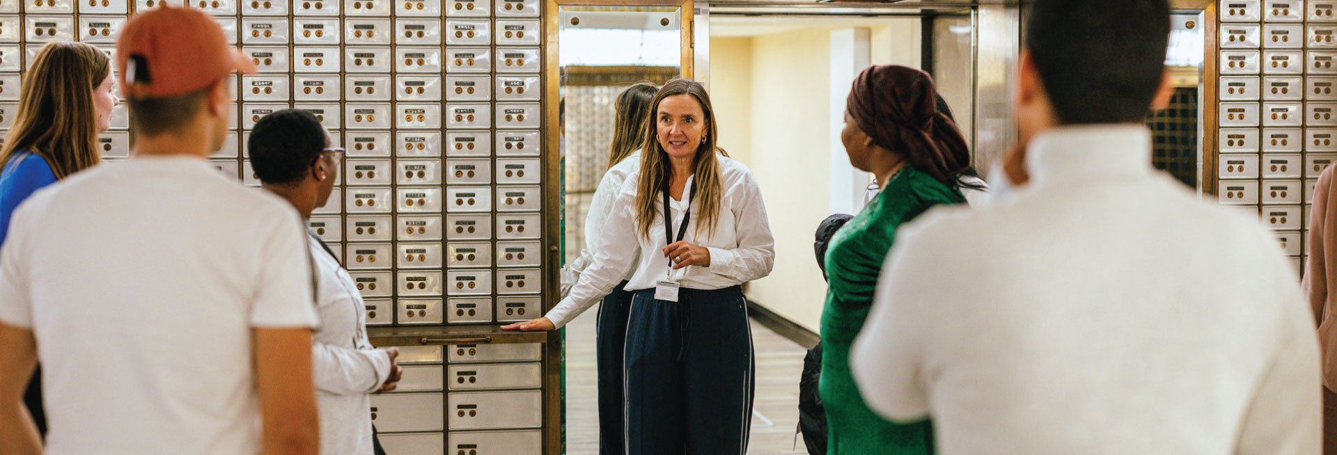A woman leads a tour within the Vaults room at The Exchange.