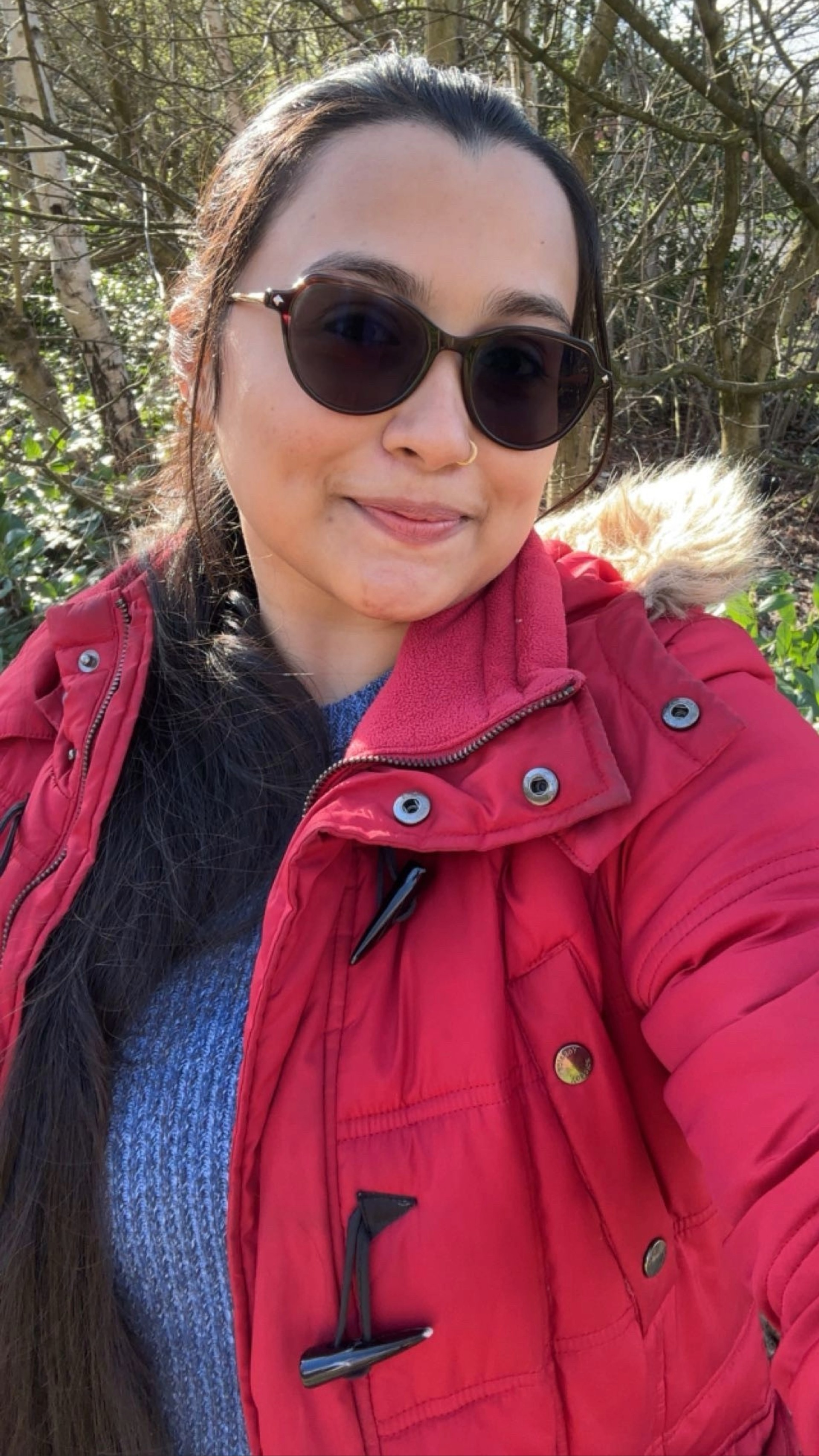 A student wearing a vibrant red waterproof jacket