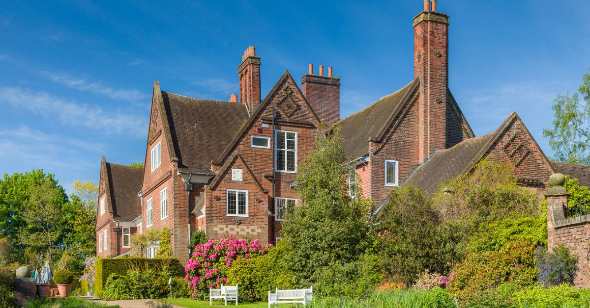 Winterbourne House surrounded by lots of green plants, trees and bushes