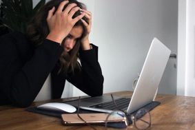 Woman looking stressed while working at a computer