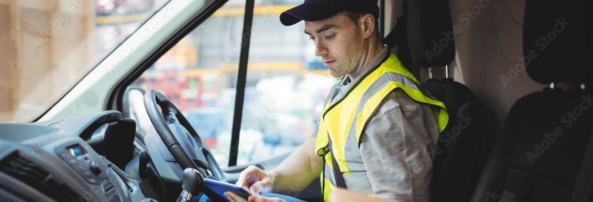 Young white male delivery driver sitting in van